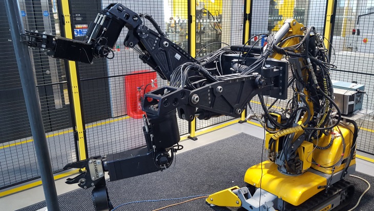 Robot with two manipulating arms grasping a pipe (Image: Lancaster University)
