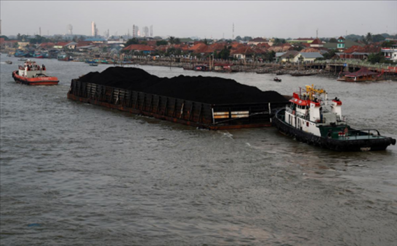 FILE PHOTO: A coal barge passes along Musi river in Palembang, Indonesia, August 15, 2018. 