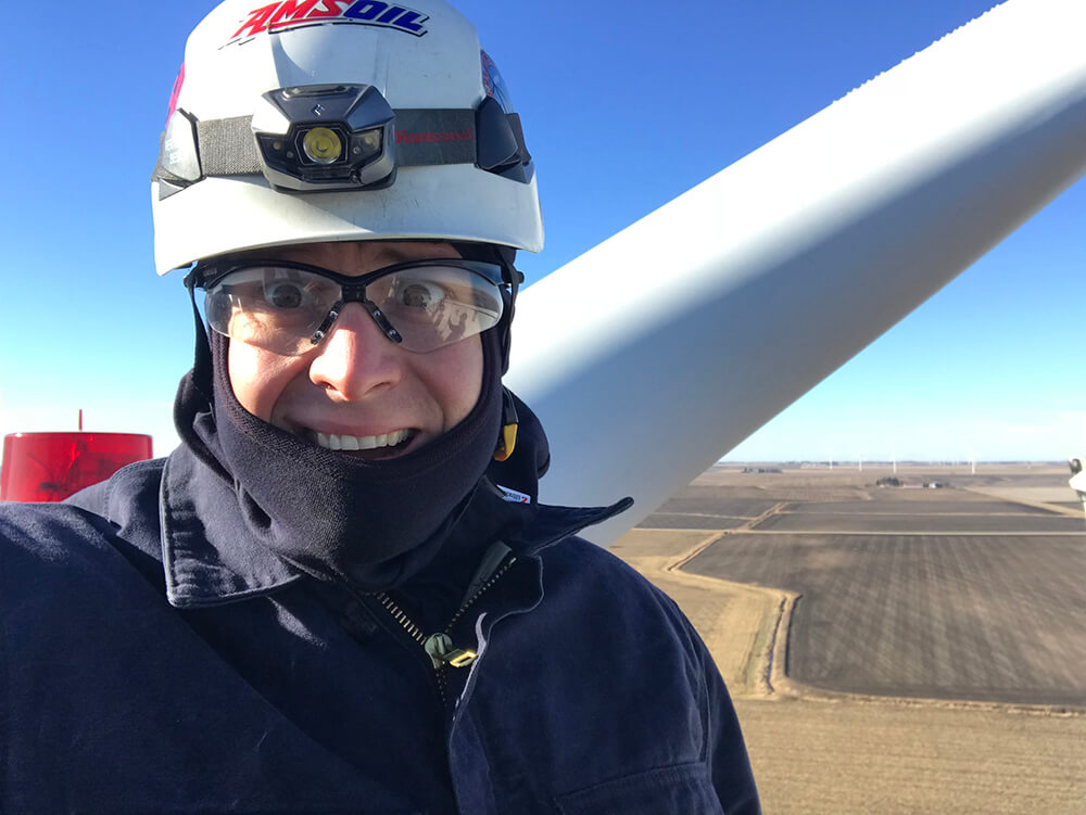 Brian Burks, a senior wind-turbine field applications’ engineer with AMSOIL, supervises an oil change on top of a Siemens 2.3-MW wind turbine.