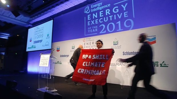 Greenpeace protestors entered the annual Oil and Money conference dinner brandishing a banner describing the two firms as “climate criminals”.