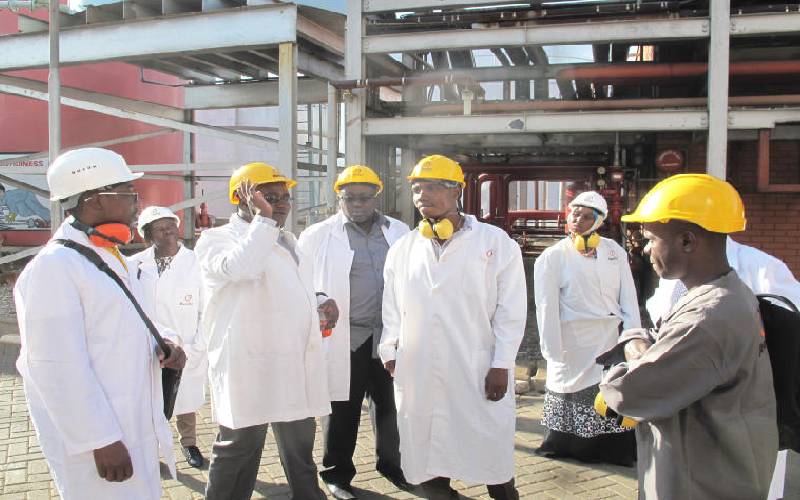 Kenya Electricity Generating Company's Engineer Reuben Wekesa (2nd left) with media crew at their Kipevu One Thermal Power Station at the Port of Mombasa. [File, Standard]
