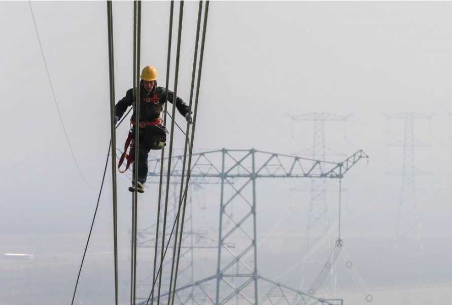 A technician examines the transmission line on an ultra-high voltage system in Huaian, Jiangsu province, in 2015. State Grid’s internet technologies project is another part of its plan to upgrade China’s power infrastructure. Photo: Xinhua