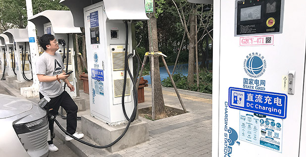A motorist charging his electric car in Beijing. The electric vehicle market in China dwarfs other countries. Stephen Shaver/UPI/Newscom