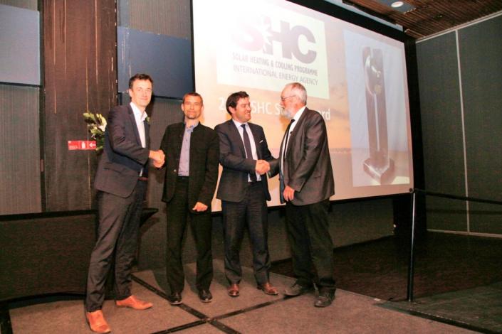 The photo shows (from left) Rémi Cuer, Investment Manager at Kyotherm, Daniel Mugnier, Chair of IEA SHC, Arnaud Susplugas, CEO of Kyotherm, and Ken Guthrie, Chair of the IEA SHC Award Committee, shaking hands at the award ceremony. The award was presented during the closing session of the International Conference on Solar Heating and Cooling for Buildings and Industry, which was held in Santiago, Chile, together with the ISES Solar World Congress.