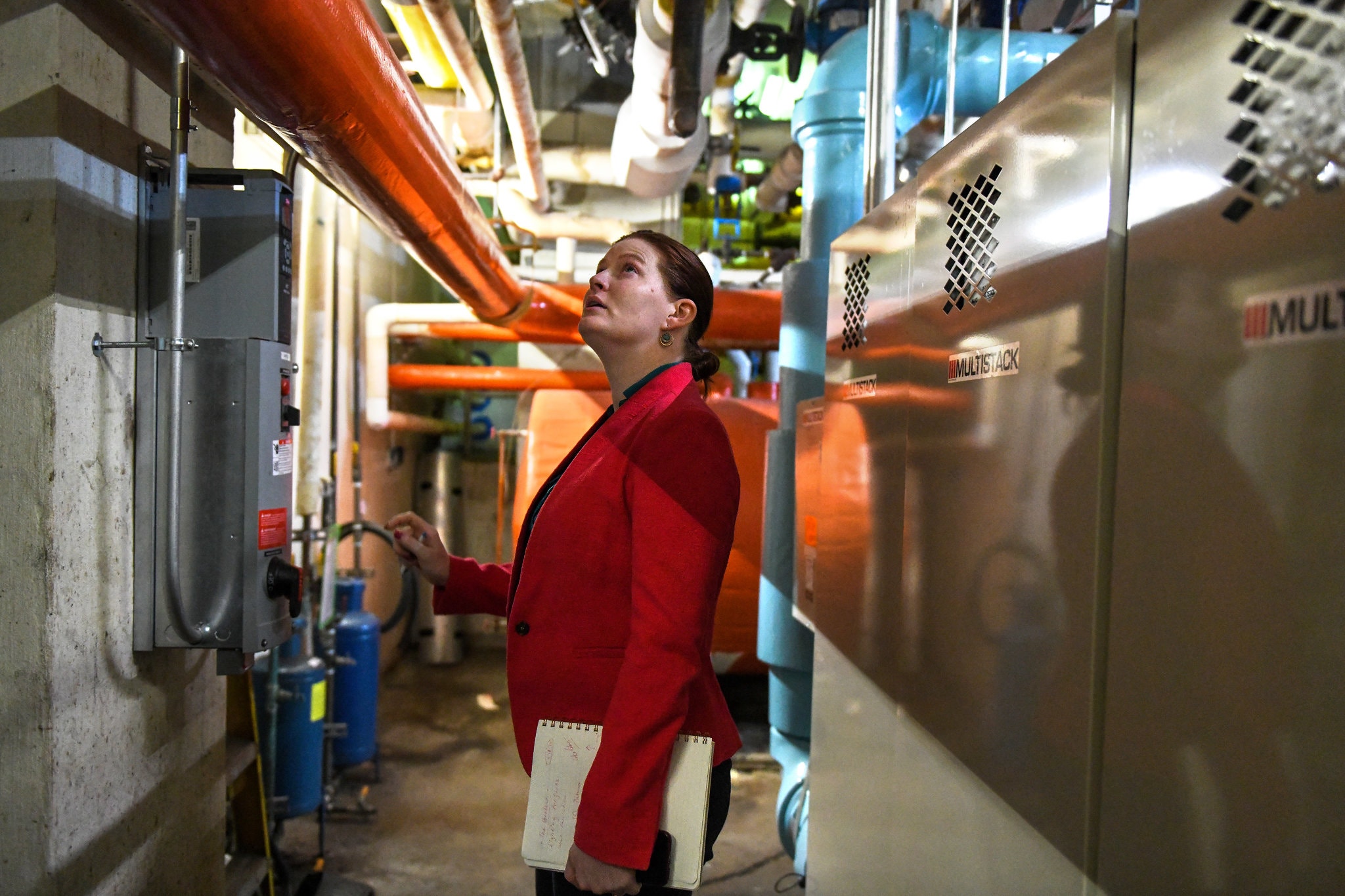 Kelly Dougherty inspects the energy-efficiency of a building in Midtown Manhattan.Credit...Desiree Rios for The New York Times