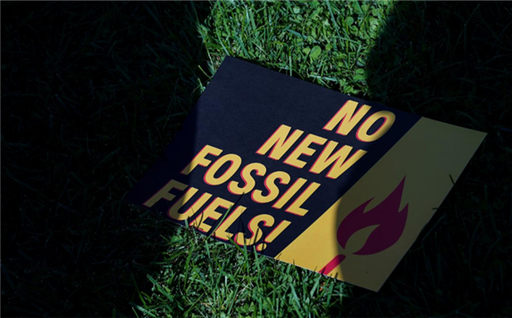 FILE PHOTO: A sign protesting fossil fuels is seen on the lawn outside of the U.S. Capitol as actor and activist Jane Fonda leads the 