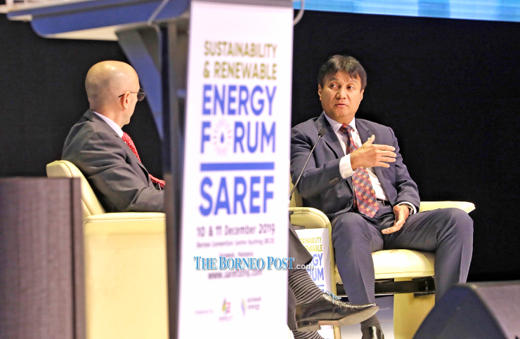 Sharbini (right) speaks to Nabili during the ‘CNBC Fireside Chat’ at Sustainability and Renewable Energy Forum here yesterday. — Photo by Chimon Upon