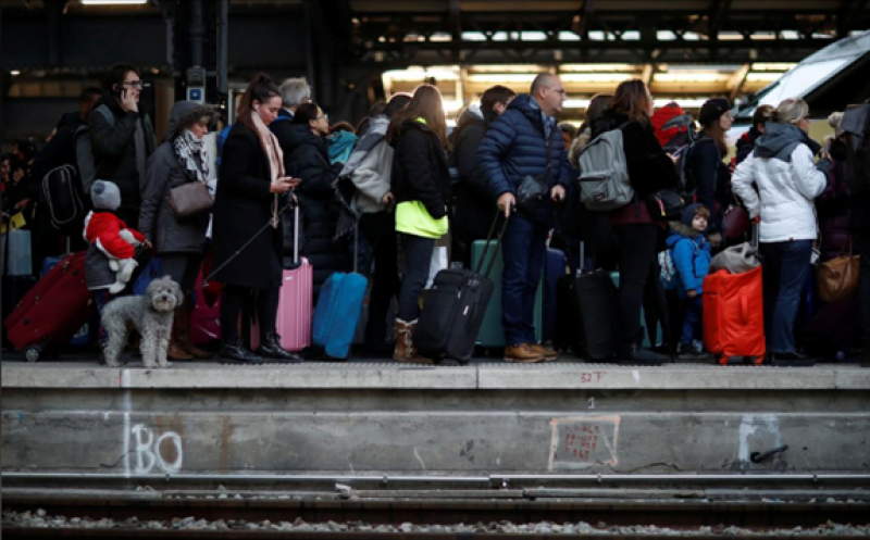 Commuters walk on a platform at Gare de l'Est train station during a strike by all unions of French SNCF and the Paris transport network (RATP) in Paris as French transportation workers' strike continues for a 19th day against pension reform plans in France, December 23, 2019. REUTERS/Gonzalo Fuentes