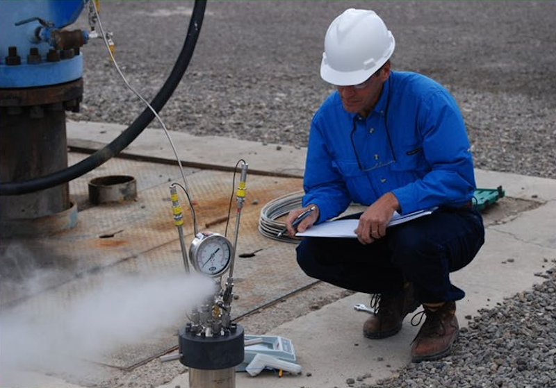 A technician monitors an engineered geothermal energy system (source: INL)