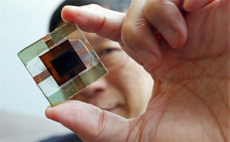 Charles Chee Surya holds a perovskite-silicon tandem solar cell with the world's highest power conversion efficiency. Credit: K.Y. Cheng Getty Images