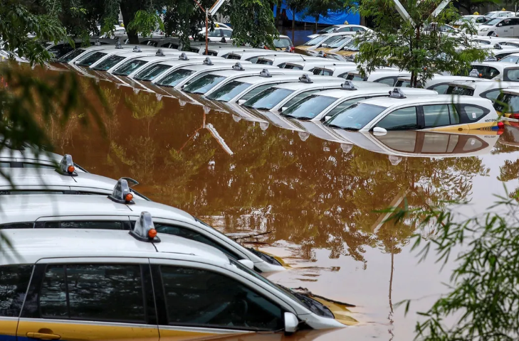 A fleet of flooded taxis are seen at the operator's submerged parking lot following overnight rain in Jakarta on Jan. 1. RALIA / AFP / Getty Images