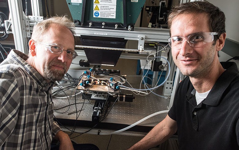 Scientists John Geisz (left) and Ryan France fabricated a solar cell that is nearly 50% efficient. Photo by Dennis Schroeder, NREL