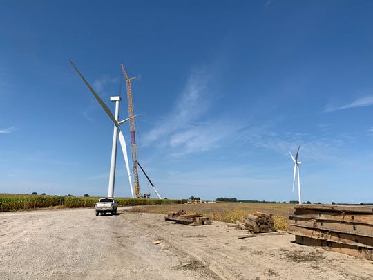 A crane hoists the blades of a new wind turbine to the top of a tower at DTE Energy's Polaris Wind Farm in mid-Michigan, recently activated according to a company announcement on April 23, 2020. 