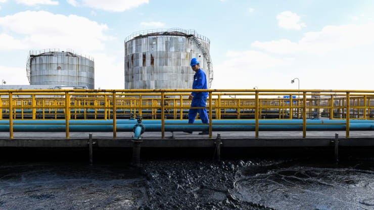 A worker examines a sewage recycling pool in the coal liquefaction factory of CHN Energy in Ordos, north China's Inner Mongolia Autonomous Region, April 11, 2019.