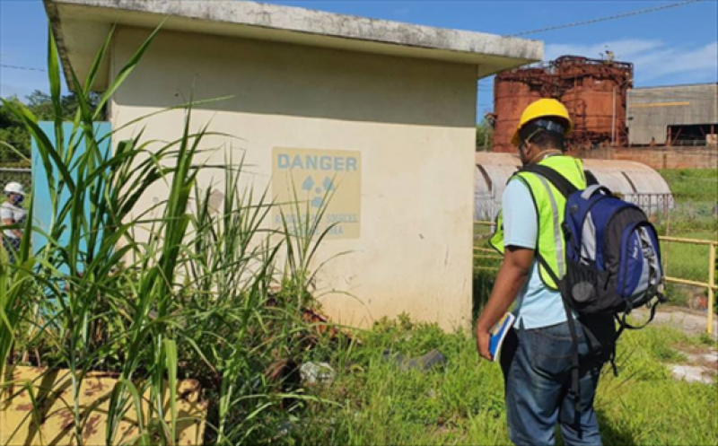 Michael Sappleton, one of the HSRA Inspectors at West Indies Alumina Company’s Kirkvine Works, sweeps the area to check for any radiation source that might be present using the Atomex radiation detection backpack. (Photo: HSRA)