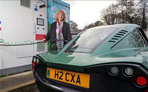 Councillor Jane Pratt poses for a photograph as she recharges a Riversimple hydrogen powered 'Rasa' car in Abergavenny, Wales on November 23, 2020. © Geoff Caddick, AFP