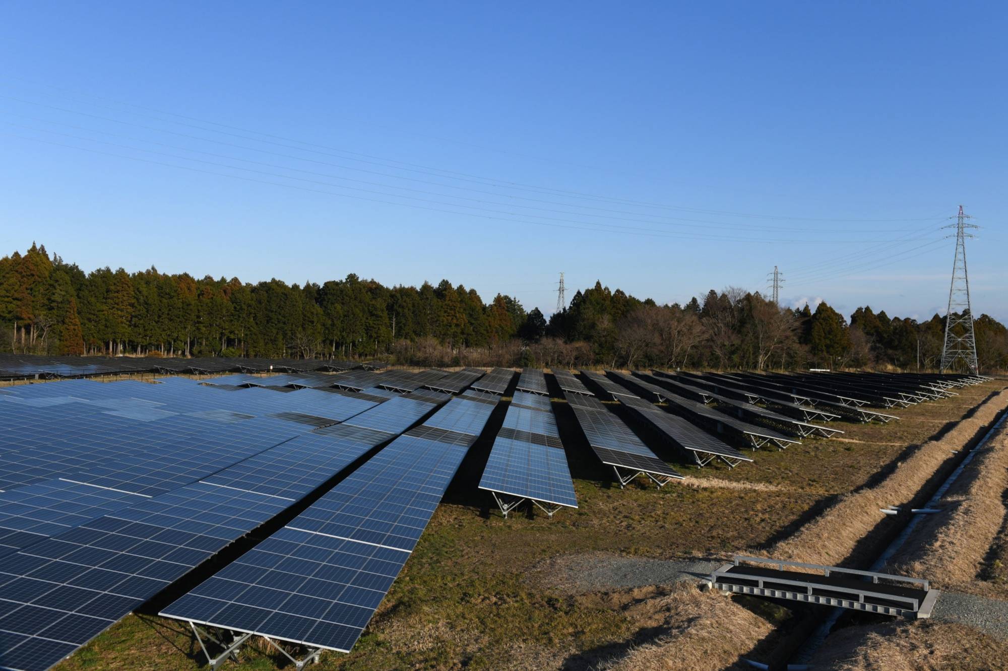 Solar panels installed by Fukushima Electric Power Co. stand in Tomioka, Fukushima Prefecture, last February. | BLOOMBERG