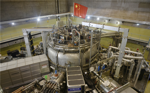FILE - A Chinese flag is seen atop the Experimental Advanced Superconducting Tokamak (EAST), a nuclear fusion reactor in Hefei, Anhui province, China, Nov. 14, 2018.