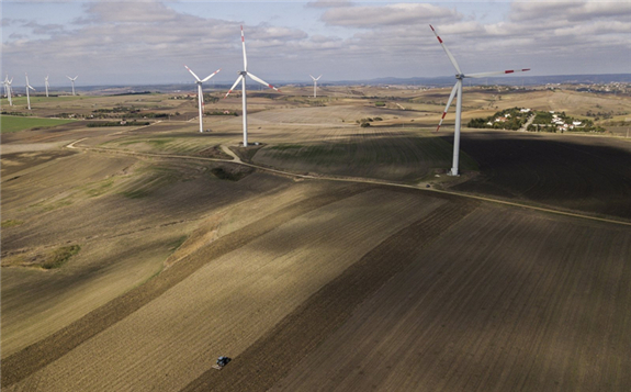 A Turkish farmer plows his fields with a tractor near wind turbines in the Istanbul countryside, Turkey, Oct. 22, 2020. (EPA Photo)