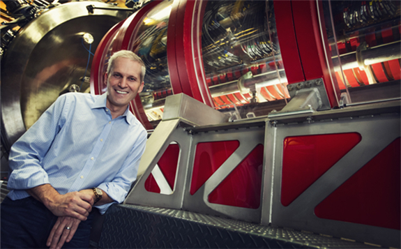 TAE Technologies Michl Binderbauer standing next to the company’s novel fusion reactor. Image Credits: TAE Technologies