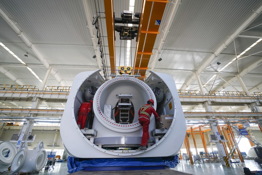 Employees work at a wind turbine plant of Goldwind Science and Technology Co.,Ltd. in Hami, northwest China's Xinjiang Uygur Autonomous Region, April 25, 2020. (Xinhua/Zhao Ge)