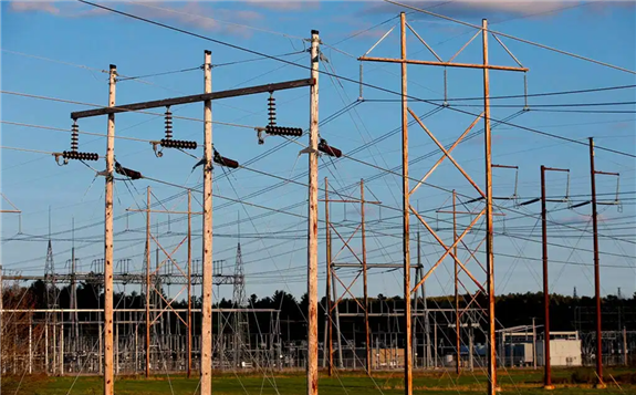 In this May 28, 2019, file photo, power lines power lines converge on a Central Maine Power substation in Pownal. Credit: Robert F. Bukaty / AP