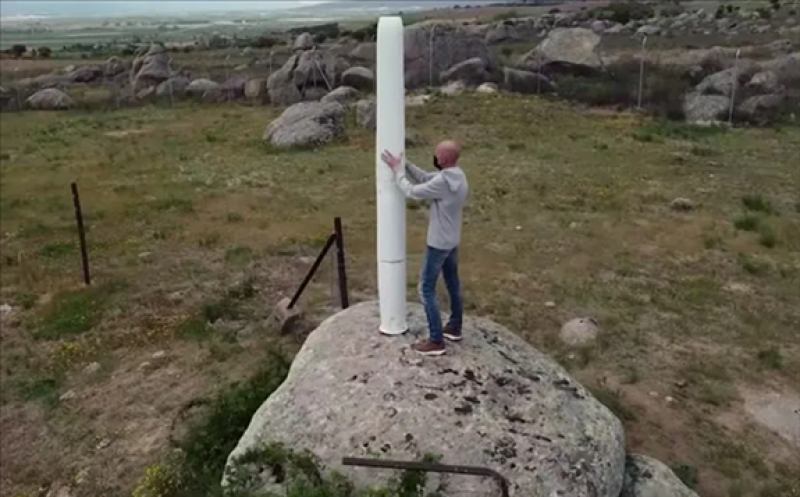 Vortex Bladeless co-founder David Yanez stands next to an oscillating 2.75 metre bladeless prototype set up in the countryside near Avila, Spain, where the company is based. (Reuters)