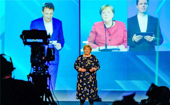 Norway's Prime Minister Erna Solberg and German Chancellor Angela Merkel (on screen) participate in the official opening of NordLink, the first power connection between Norway and Germany, in Oslo, Norway May 27, 2021. Gorm Kallestad/NTB/via REUTERS
