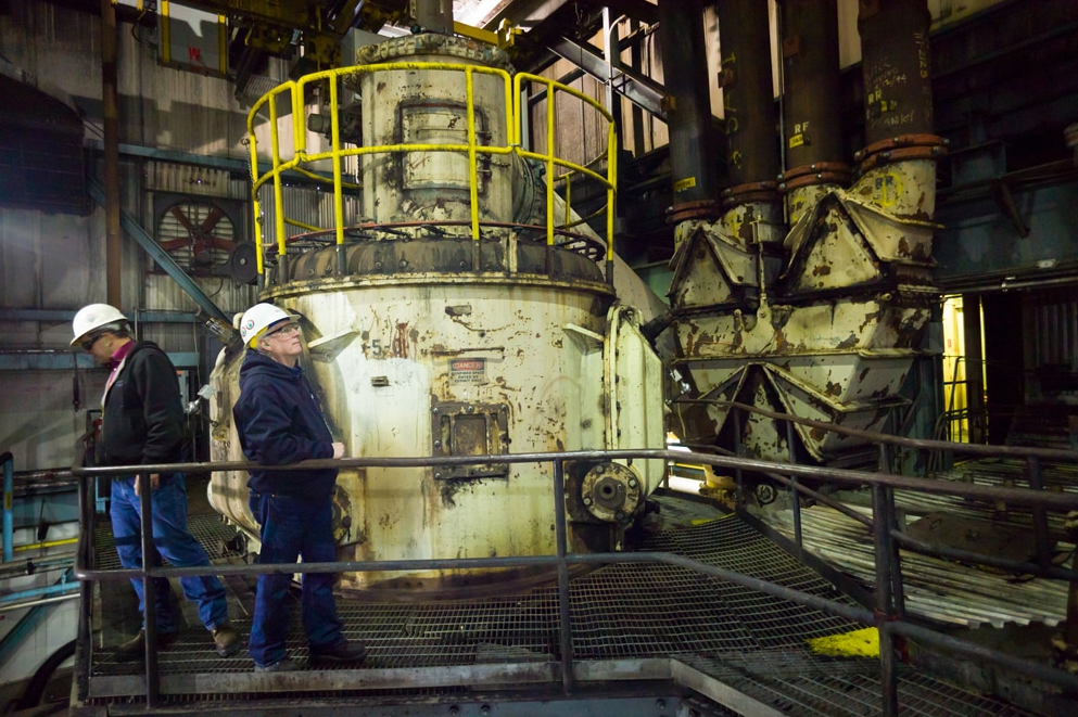 Dave Eskelsen surveys the Unit 3 coal grinder at the Naughton Power Plant. The unit shut down in January of 2019. Plant manager Rodger Holt, behind him, looks down from the two-story-high machine that environmental regulations and market forces have sidelined. (Angus M. Thuermer Jr./WyoFile)