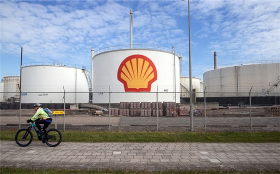 A cyclist passes oil silos at the Royal Dutch Shell Pernis refinery in Rotterdam, Netherlands, on Tuesday, April 27, 2021. Peter Boer | Bloomberg | Getty Images