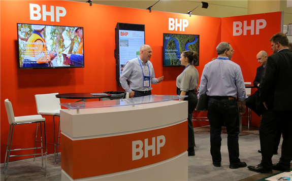 Visitors to the BHP (formerly known as BHP Billiton) booth speak with representatives during the Prospectors and Developers Association of Canada (PDAC) annual convention in Toronto, Ontario, Canada March 4, 2019. REUTERS/Chris Helgren/File Photo