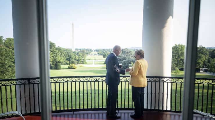  handout photo provided by the German Government Press Office of German Chancellor Angela Merkel and U.S. President Joe Biden stand in the White House with a view of the Washington Monument on July 15, 2021 in Washington, DC. Guido Bergmann | Handout | Getty Images News | Getty Images