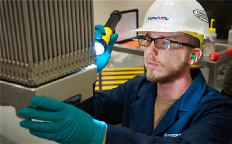 A worker visually inspects a Framatome advanced nuclear fuel assembly (Image: Framatome)