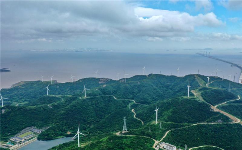 ind turbines rotate as sea breezes flow through the Cengang Wind Farm in Zhoushan, East China's Zhejiang Province on Tuesday. The farm delivered 29.88 million kilowatt-hours of green power into the national grid from January to May this year. It's calculated that's enough to reduce carbon dioxide emissions by about 24,300 tons. Photo: cnsphoto