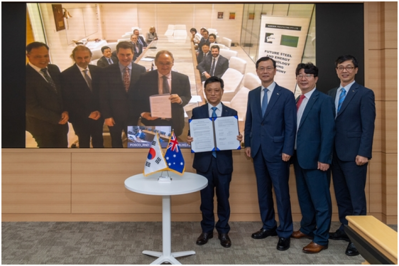 Kim Hak-dong (fourth from right), head of POSCO’s Steel Division, and other POSCO officials pose for a photo after signing an agreement with Roy Hill online. Officials of Roy Hill are seen in the screen on the left side of the photo.