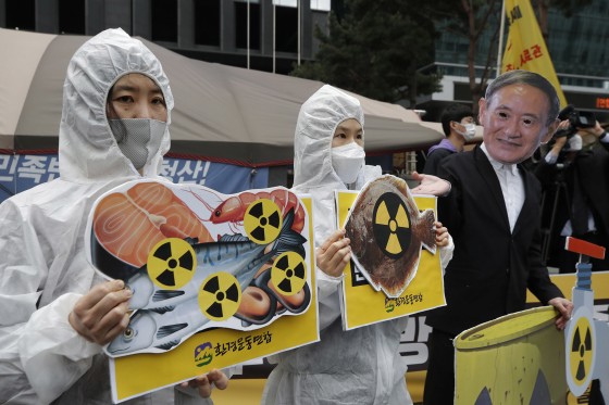 Environmental activists in protective suits protest Japan's decision on Fukushima water, near the Japanese embassy in Seoul, South Korea, in April. Lee Jin-man / AP file Increasing amounts