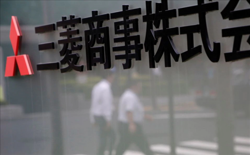 Pedestrians are reflected on a signboard of Mitsubishi Corp at its head office in Tokyo, Japan August 2, 2017. REUTERS/Kim Kyung-Hoon