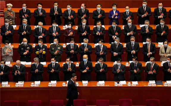 Delegates applaud as Chinese President Xi Jinping arrives for the opening session of China's National People's Congress in March. Xi announced last week that China would stop financing coal projects abroad. AP Photo/Andy Wong
