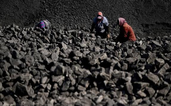 Workers sort coal near a coal mine in Datong, China’s northern Shanxi province on November 3, 2021. Noel Celis | AFP | Getty Images