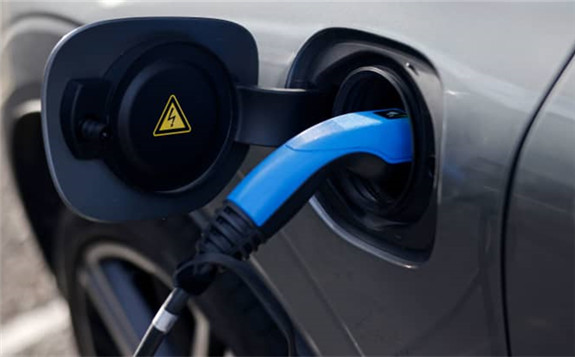 A charging cable plugged into a Volvo electric vehicle in London on November 18, 2020.TOLGA AKMEN | AFP | Getty Images