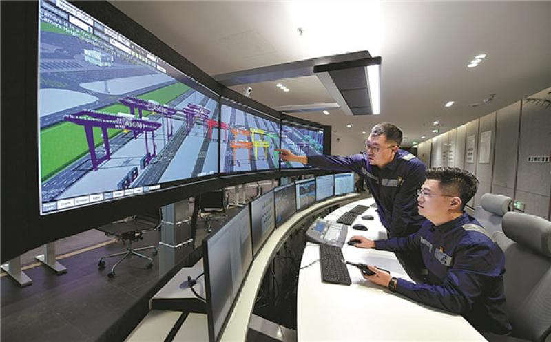Technicians work in the central control room of Tianjin Port's new terminal. [Photo/China Daily]